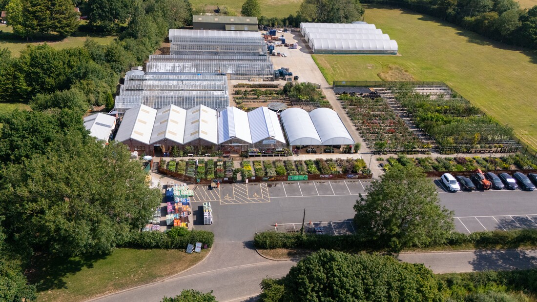 Aerial view of Homestead Nurseries on a sunny day, showing five acres of nursery beds and greenhouses